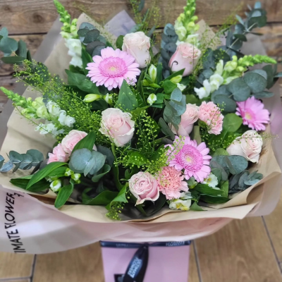 Pink Pearl - A beautifully soft bouquet in delicate pink and white tones, complemented by silvery foliage and fresh greenery for an elegant finish.