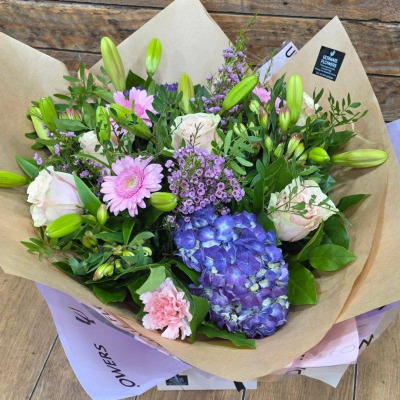Violet Horizon - A beautiful bouquet blending soft pinks with striking blue and purple tones, complemented by fresh greenery for a vibrant, elegant finish.