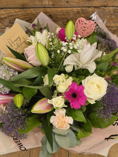 Pink Delight - A charming bouquet of soft pinks, vibrant cerise and creamy whites, beautifully balanced with fresh greenery.