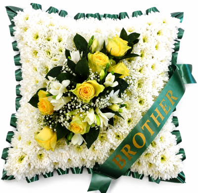 Funeral Cushion Green - A traditional cushion tribute in crisp white and warm yellow tones, finished with deep green ribbon and a graceful floral accent.